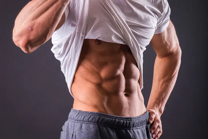 Muscular physique symbolizing the effects of growth hormone and IGF-1 on protein synthesis, lean muscle gain, faster recovery, and reduced fat storage, as studied in bulking research.
